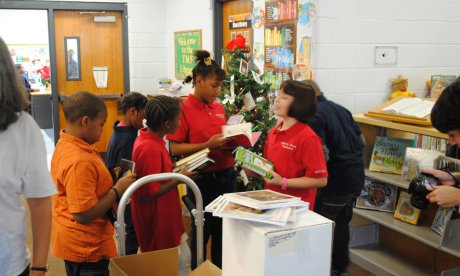 Photo of curious students looking through donated books
