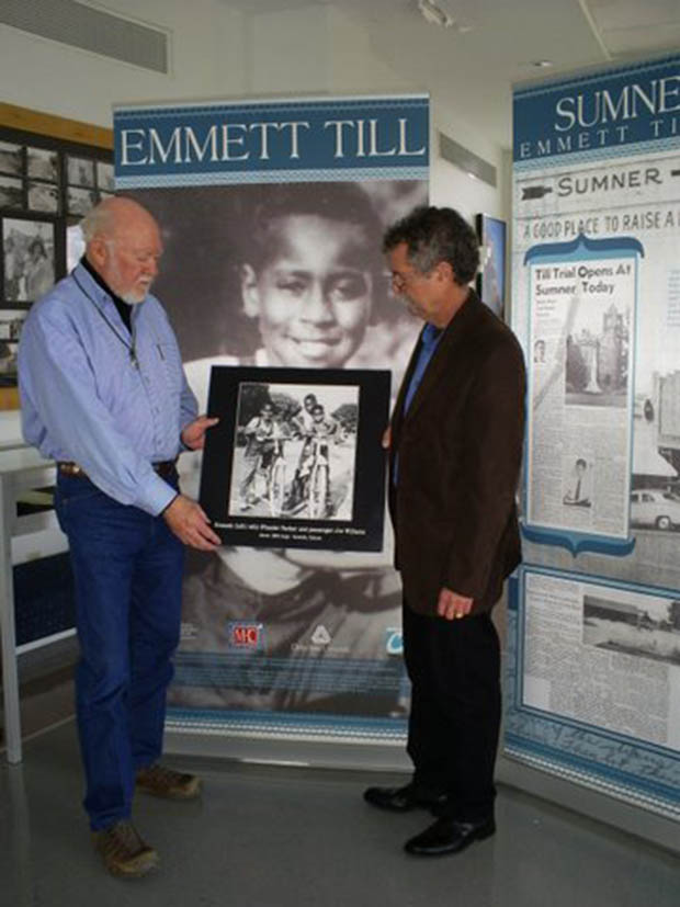 Henry Outlaw (left) and Luther Brown, the co-creators of the exhibit, are holding a photo of Emmett Till