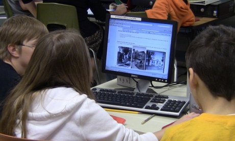 Three GeoHistorians tackling a problem on their computer screen.