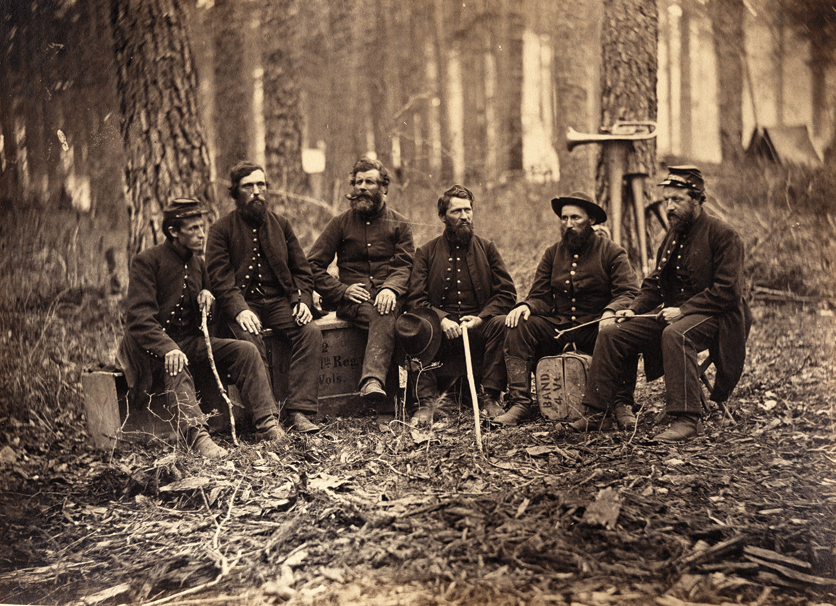 Six soldiers in the 4th Vermont Infantry seated in their encampment
