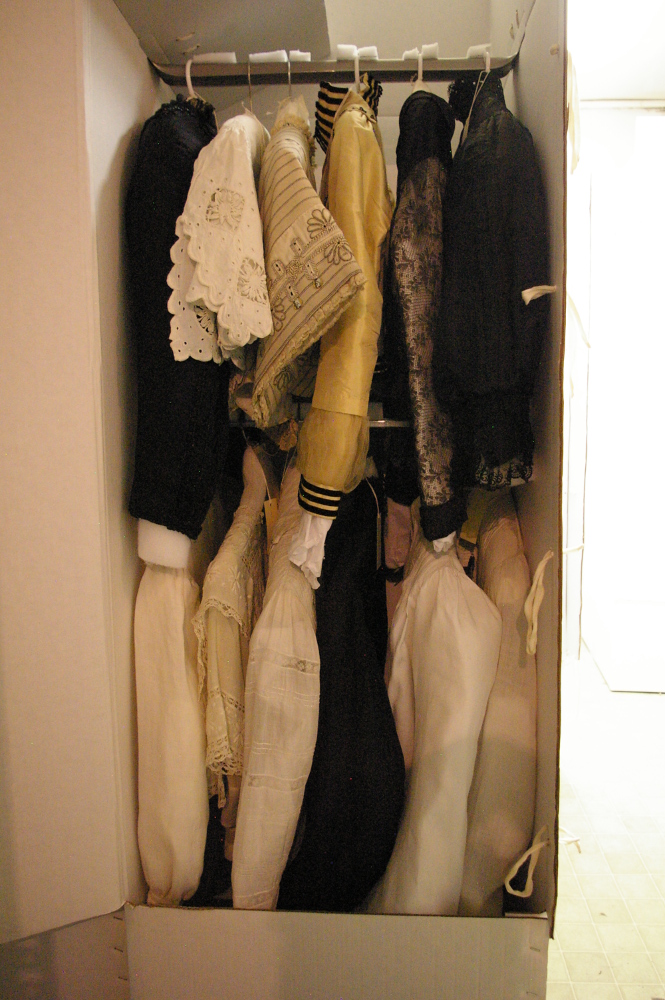 Newly rehoused hanging garments in individual archivally-safe wardrobe boxes.