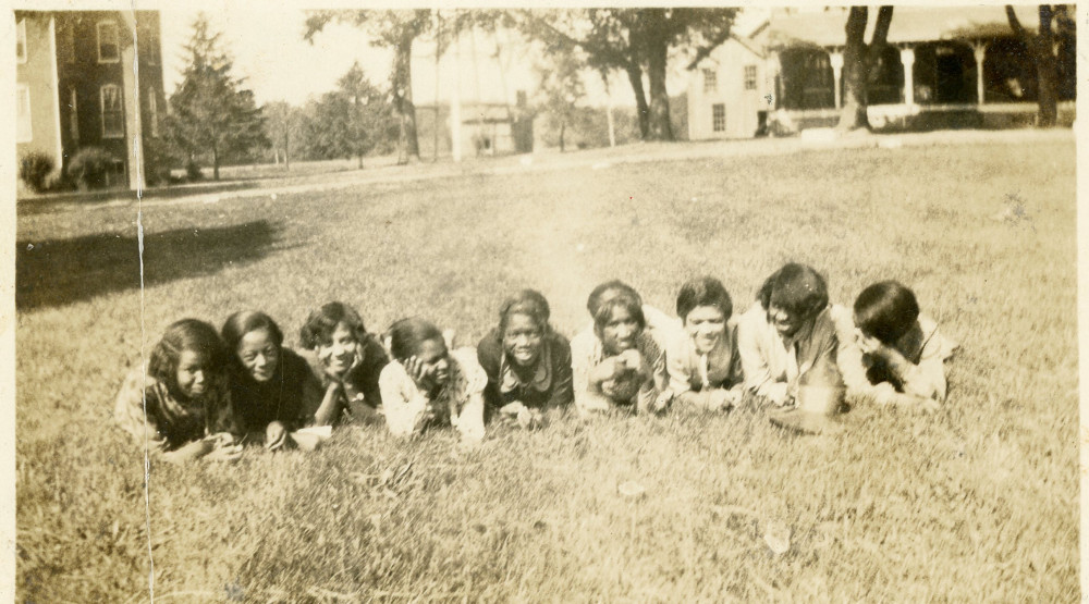 Early campus photograph of girls in the grass