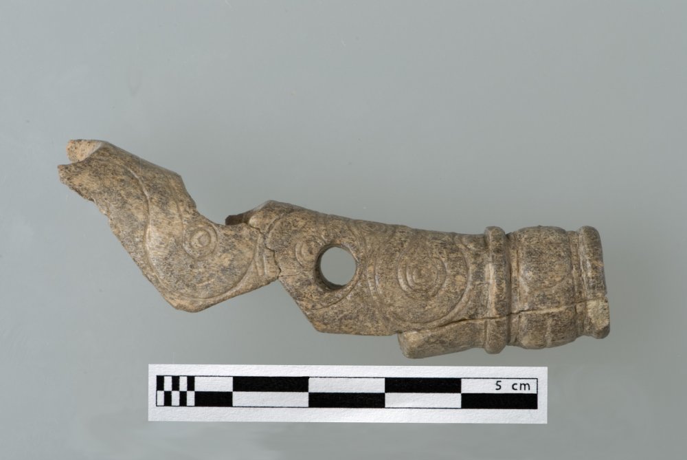 Fragment of a carved horse bridle, carved in speckled tan and gray bone