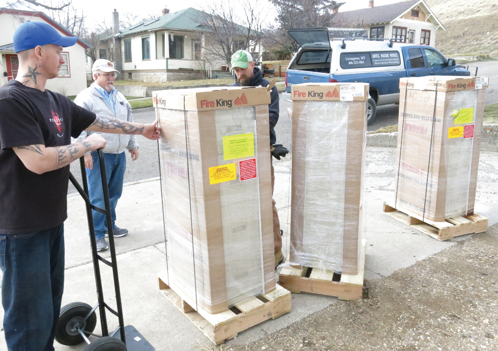 Volunteers and Director Paul Shea (center) help unload the file cabinets.