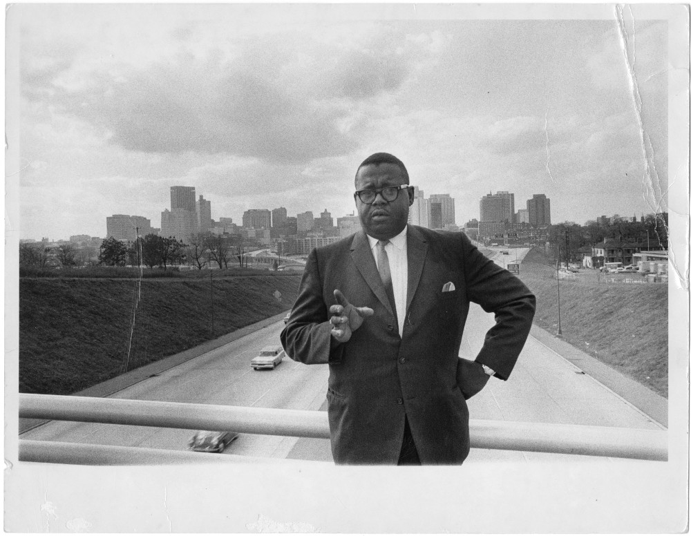 James H. Costen stands on the Spring Street bridge with the Atlanta skyline