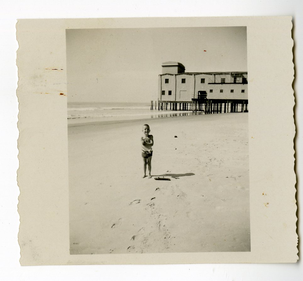 Photograph, child on 30th St. beach with Avalon Pier visible in background, 1945