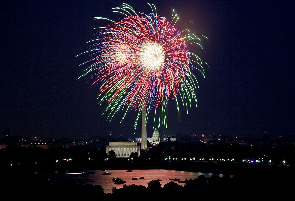 An explosion of fireworks against the night sky above the national mall in Washington, D.C.