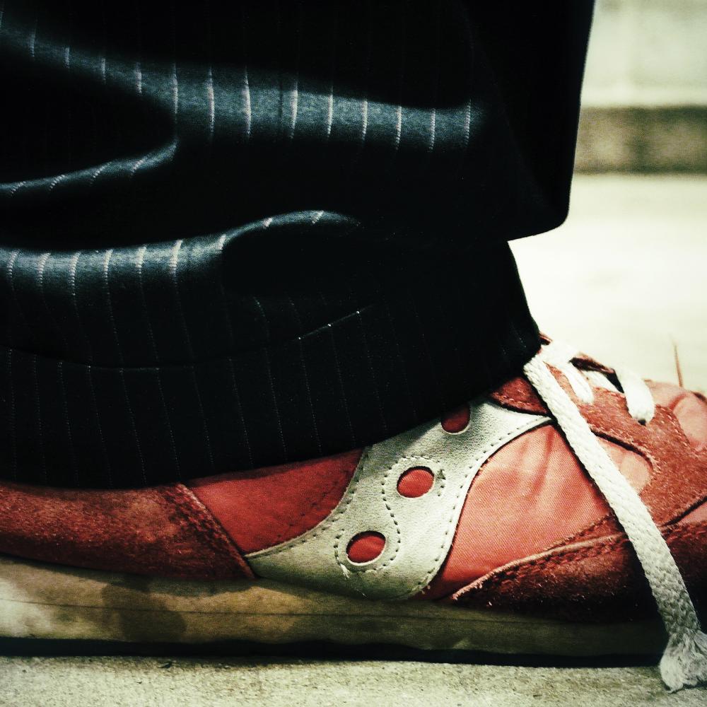 View of Garrison Keillor's shoes, red and grungy.