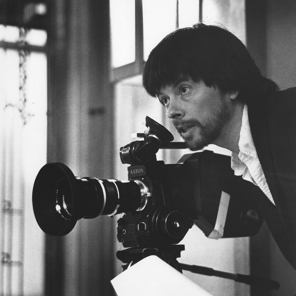 Black and white photo of Ken Burns wielding a camera.