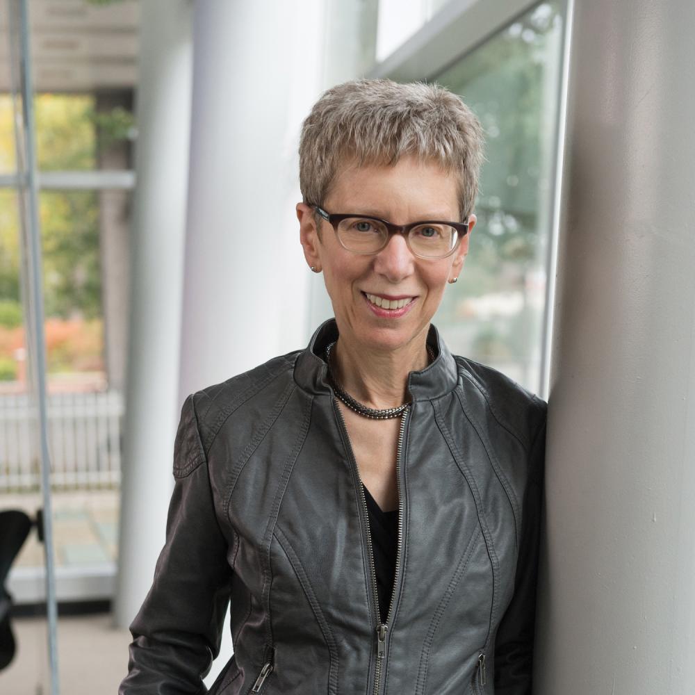 Terry Gross, standing with her hands in her pockets