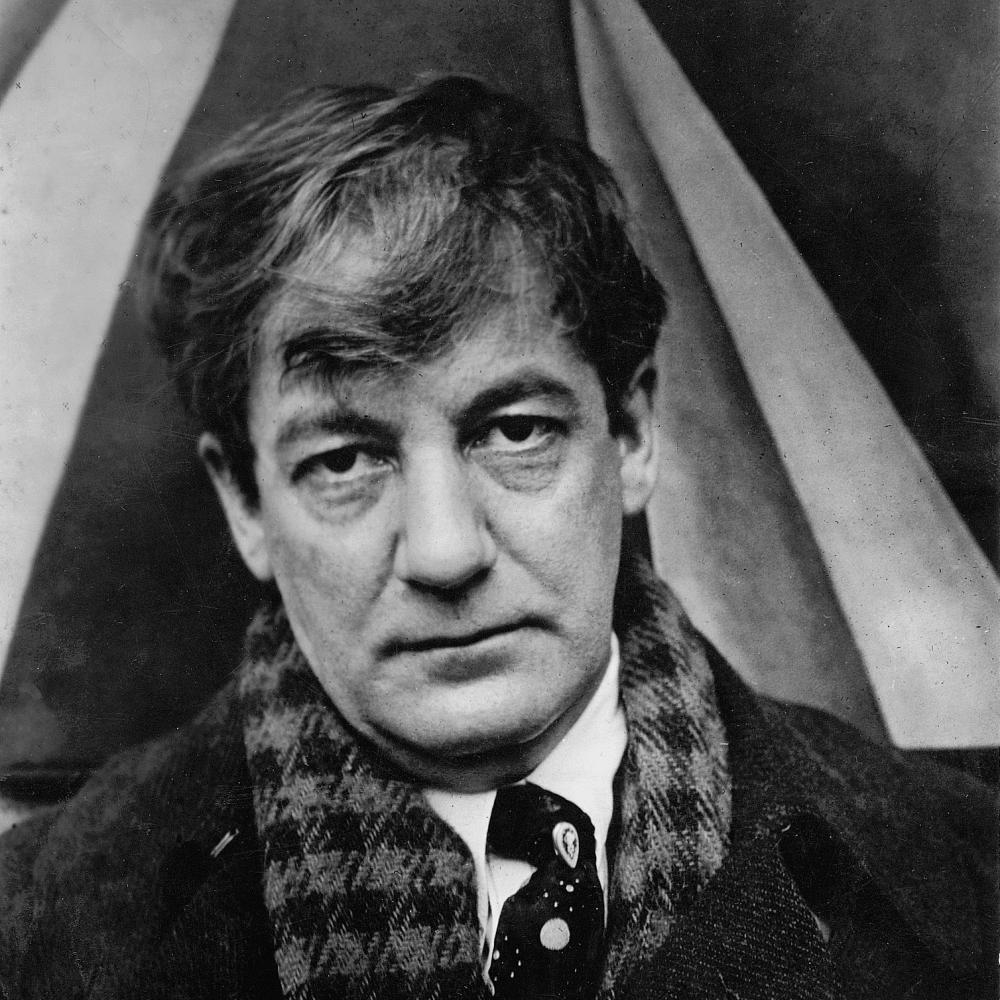 Black and white photograph of Sherwood Anderson, wearing a checkered scarf