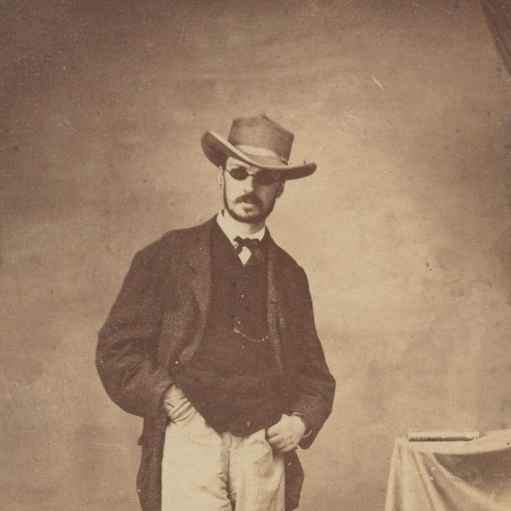 William James in 1865, wearing sunglasses and a hat