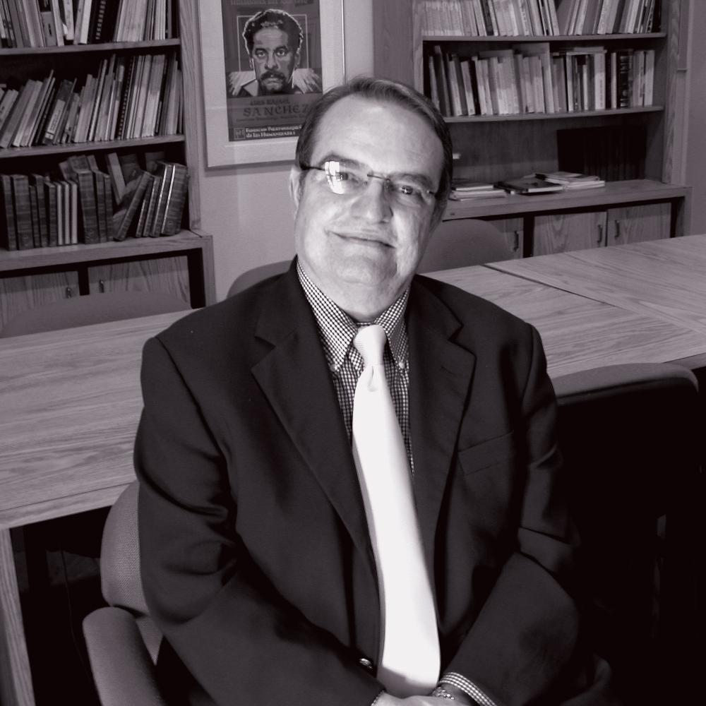 black and white photo of a man in a suit with glasses