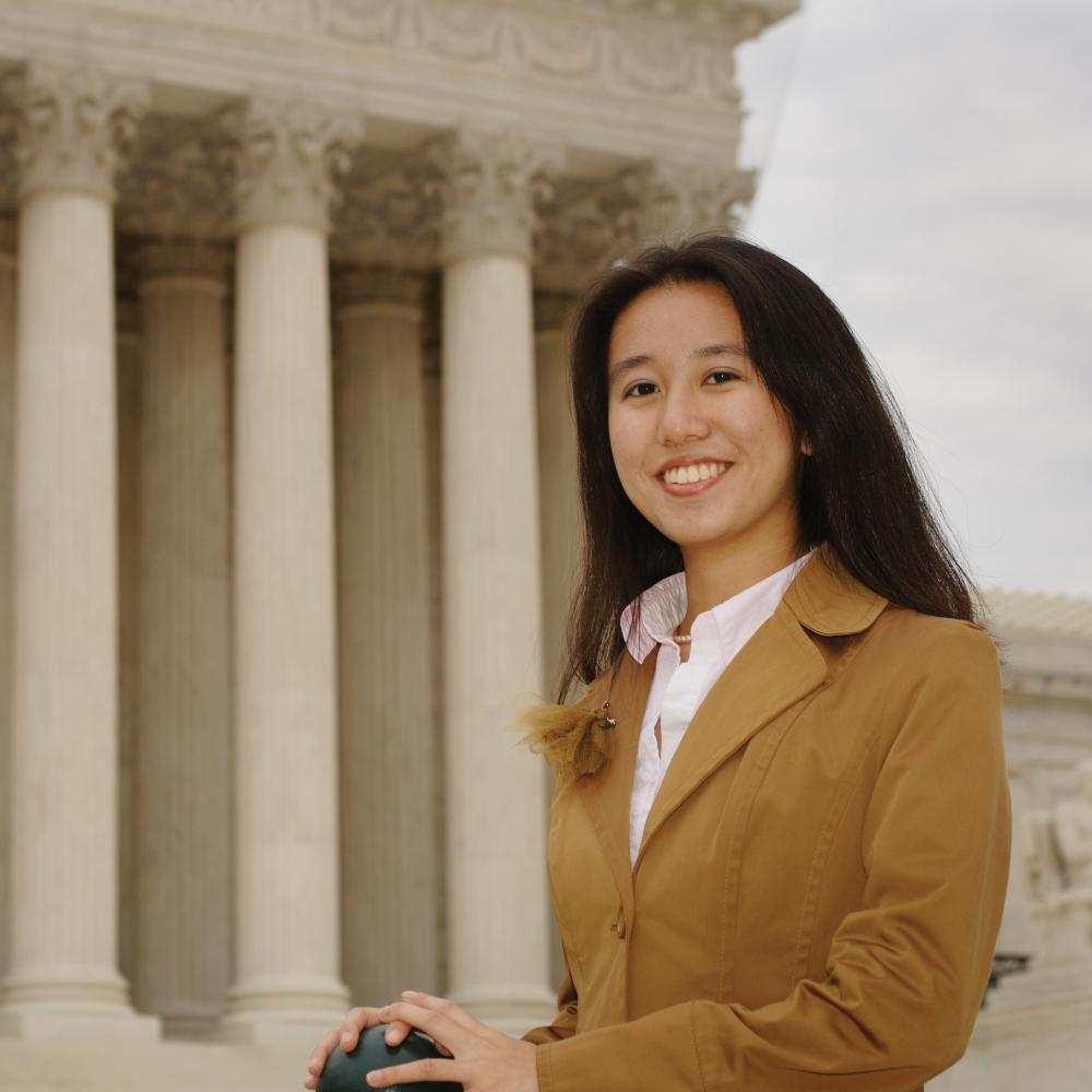 Image of young woman in front of Supreme Court building