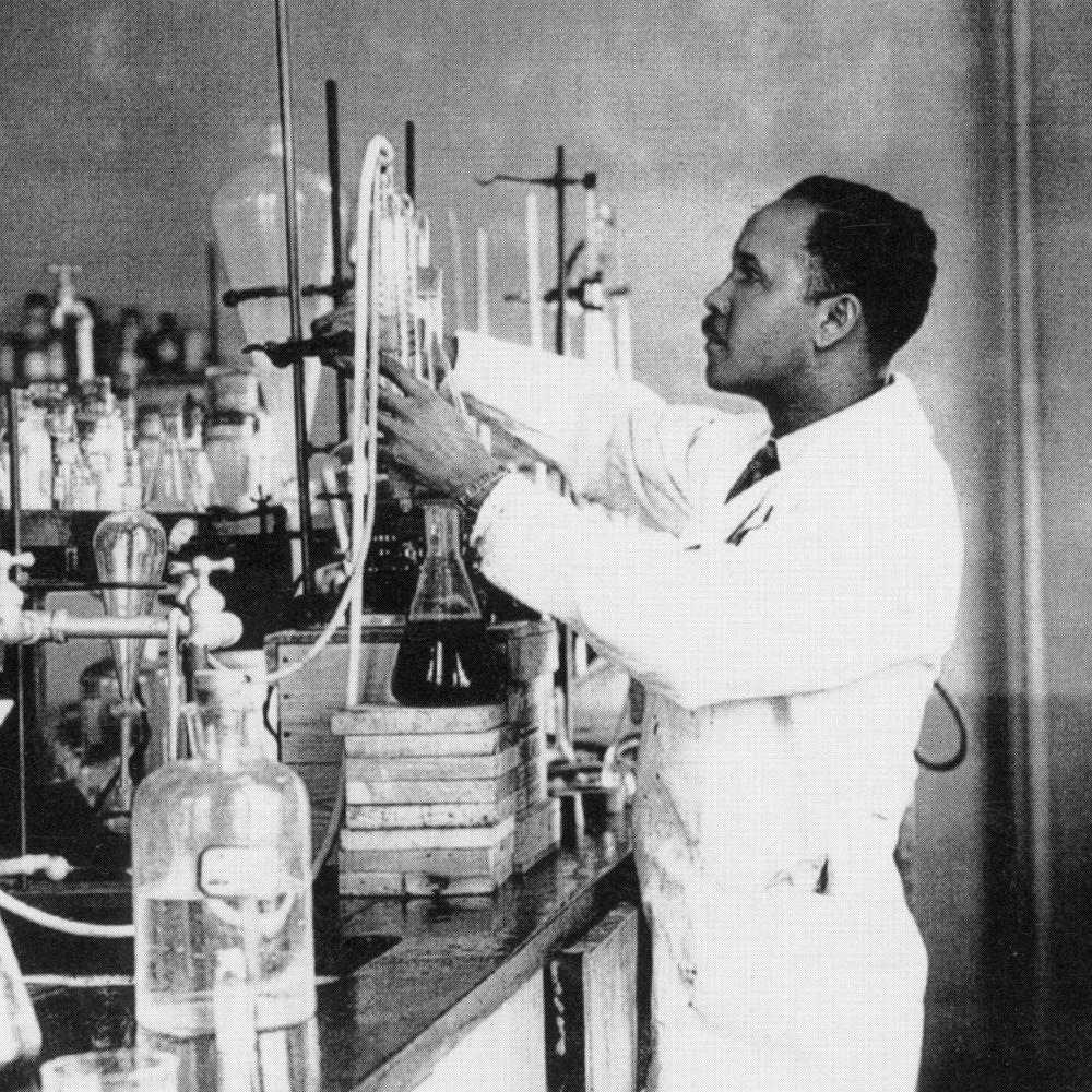 black and white photo of a man working with lab equipment