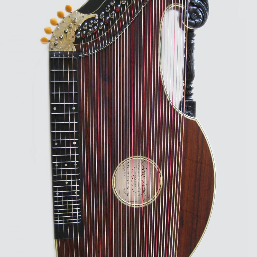 A stringed zither made of red-brown wood