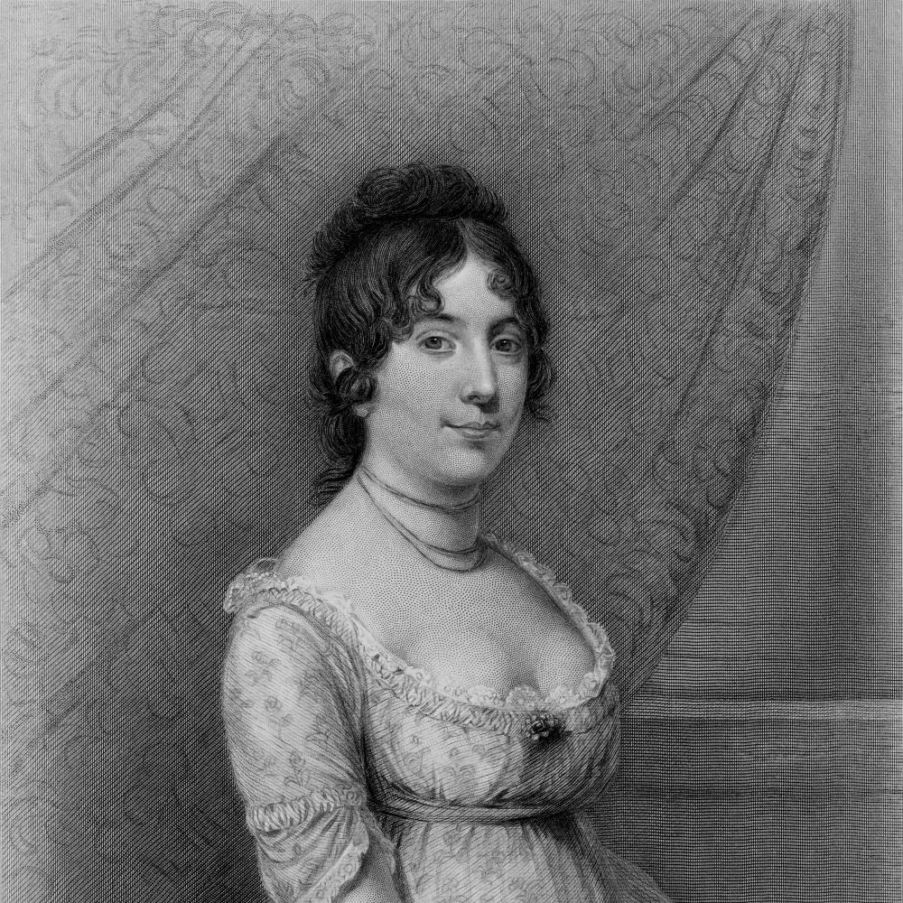 Dolley, seated, holding a fan, wearing a white lace dress with a scoop neckline