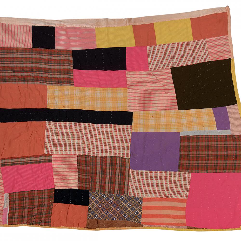 Photograph of a quilt made with various fabrics 