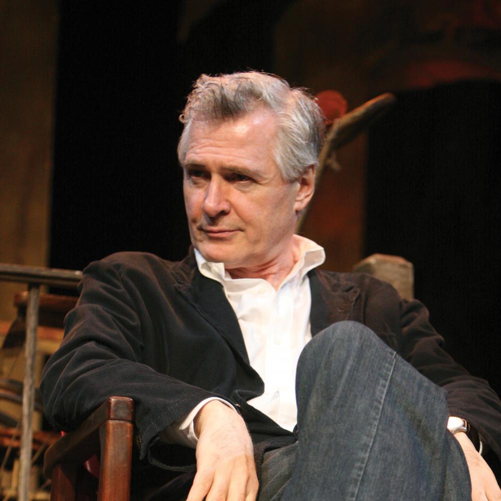 Photograph of a man sitting in a chair