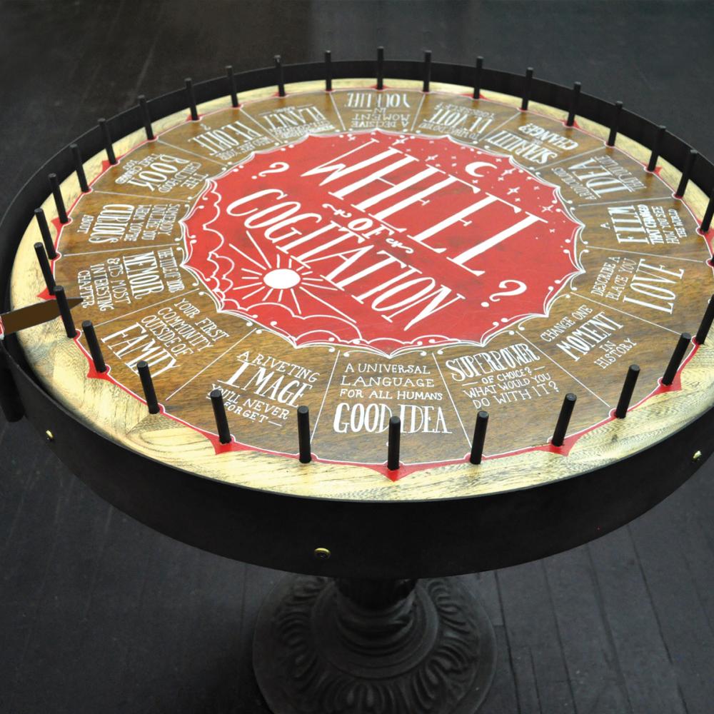 Color photo of a roulette wheel with various quirky instructions at each stop.