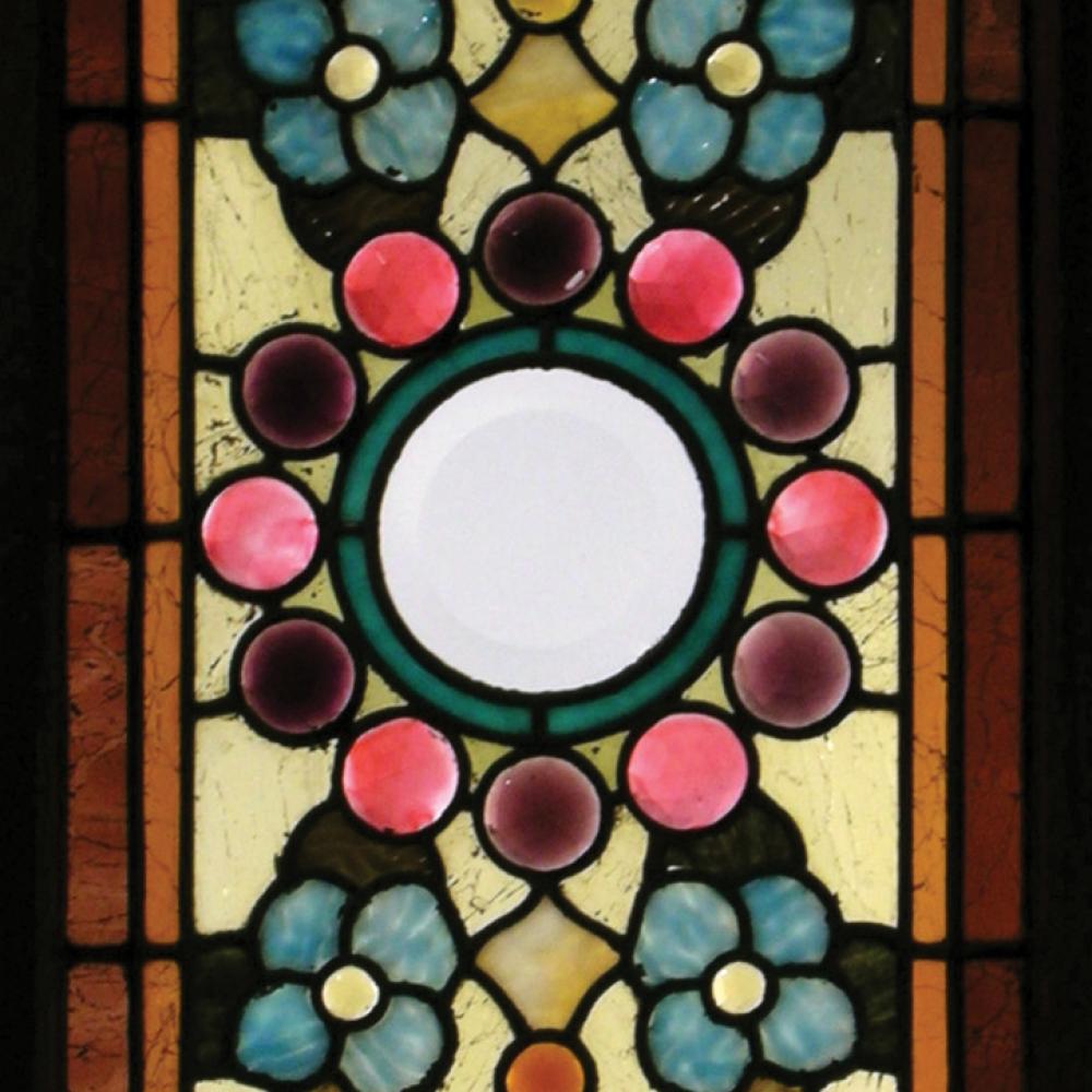 Panel of colorful stained glass in a floral pattern