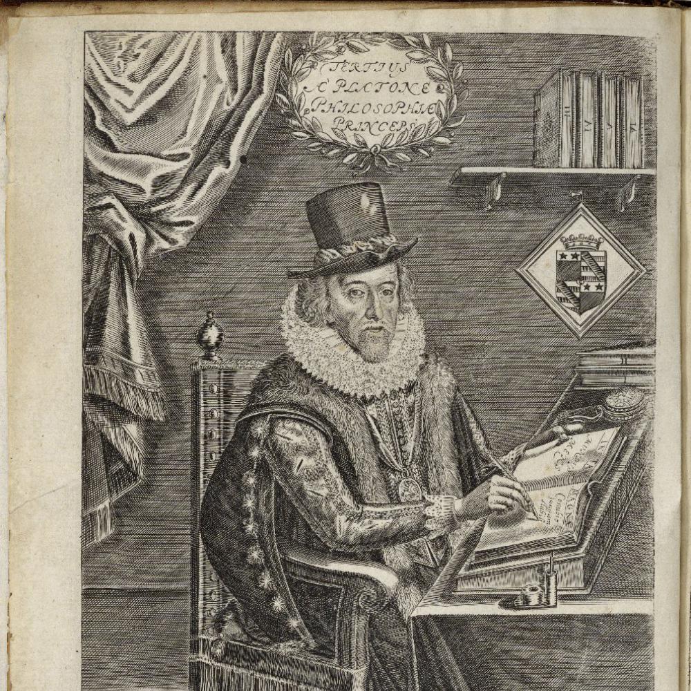 Sir Francis Bacon sitting at a desk, writing with a quill pen, dressed in a robe, fur scarf, top hat, and high ruffled lace collar