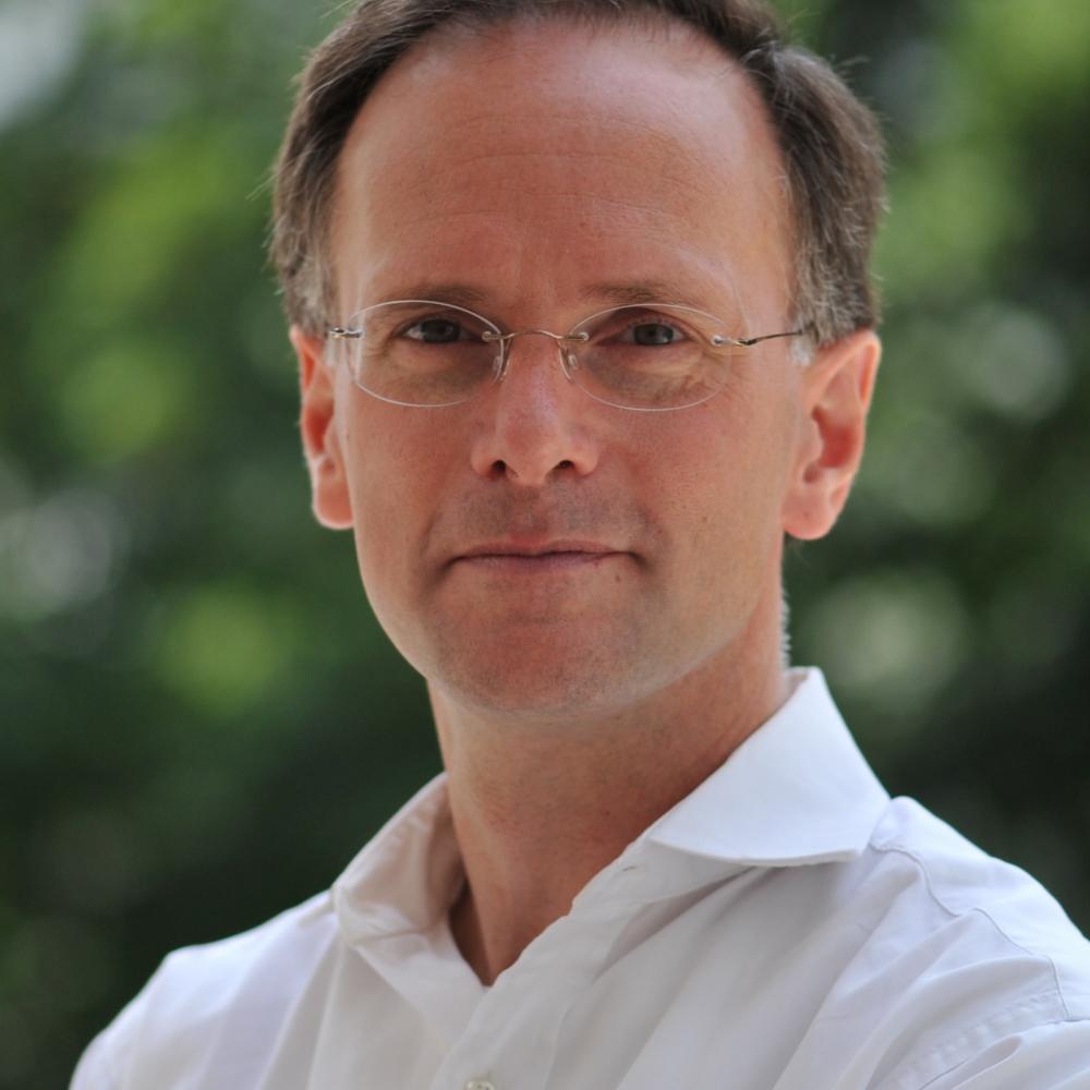 Professional photo portrait of Paul D. Halliday in a white collared shirt.