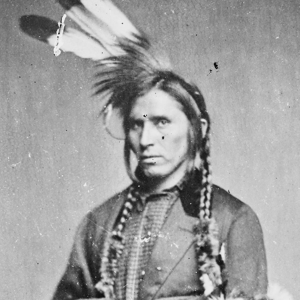 Black and white photo portrait of a Native-American man.