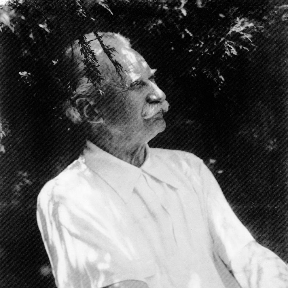 Black and white profile portrait of Jens Jensen wearing a white, short-sleeved shirt.
