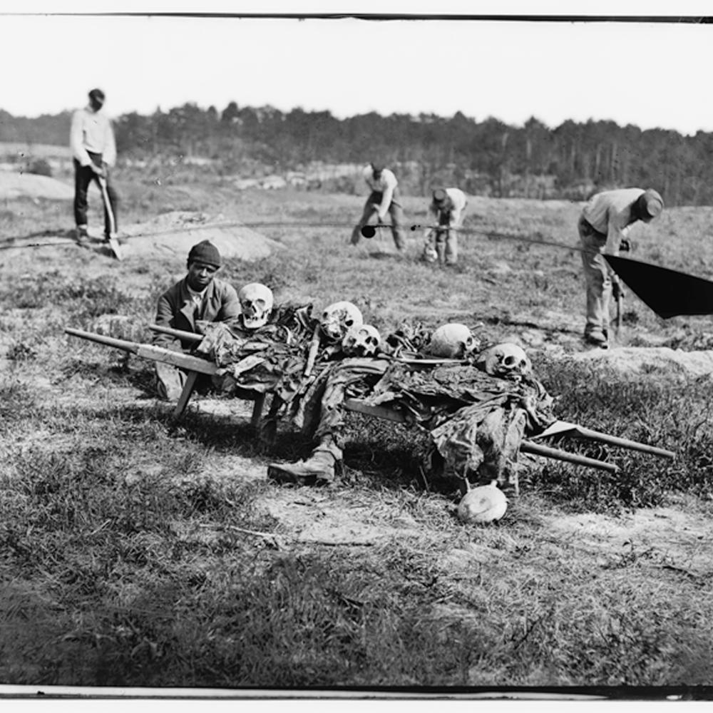 Black and white photo of African Americans carting off the bones of casualties from the Battle of Cold Harbor.