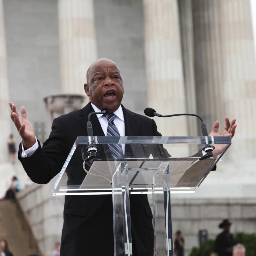 Color photo of a politician speaking in front of the Lincoln Memorial.
