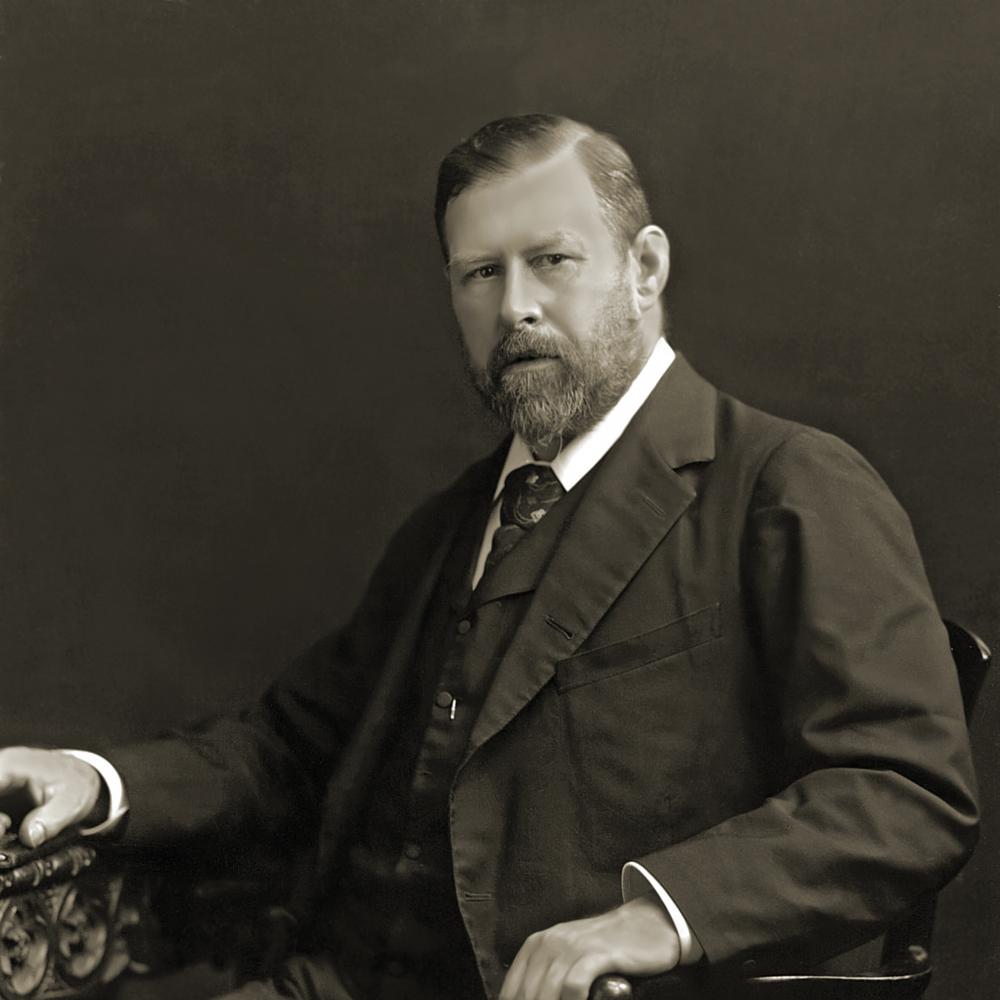 Black and white photo of Bram Stoker sitting in a chair.