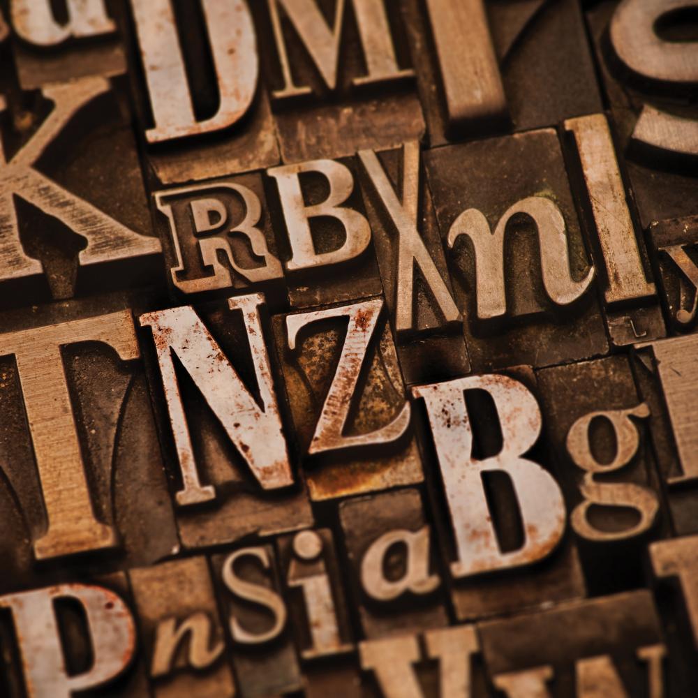Assorted letters in shades of brown, on a bronze background
