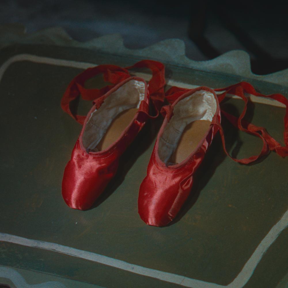 Movie still of red satin ballet shoes