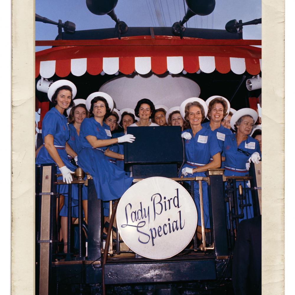 Photograph of women in blue dresses with Lady Bird Johnson