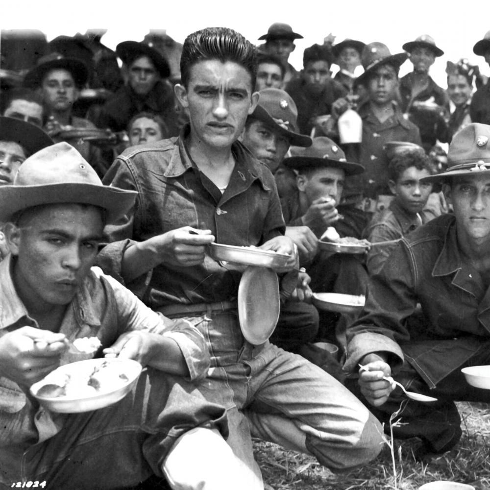 Group of Latino American soldiers sitting and resting between training maneuvers