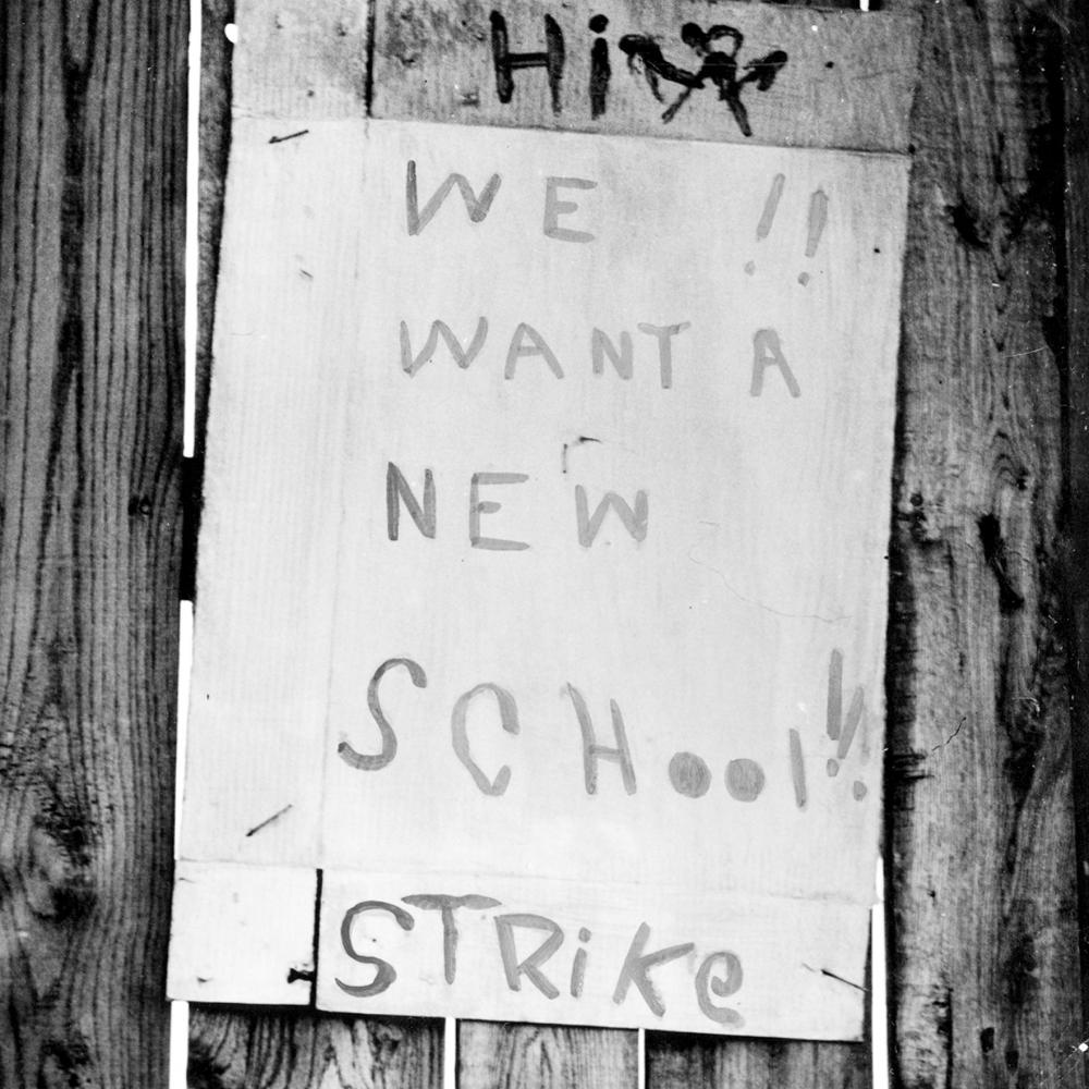 protest sign reading "we want a new school! strike"
