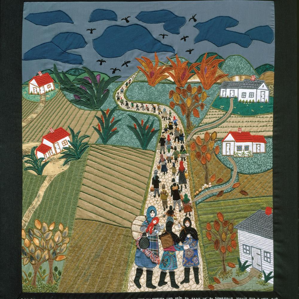 Quilt depicting people leaving a village by a road