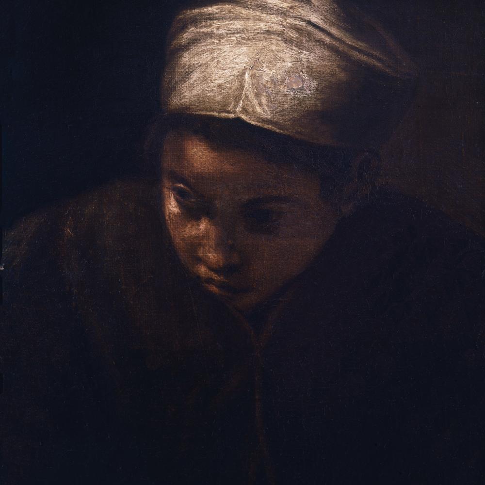 A young girl in a white headwrap, face and body obscured by heavy shadow
