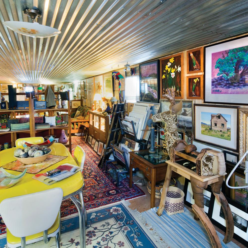 Color photo of an art gallery filled with paintings and artifacts of all types.