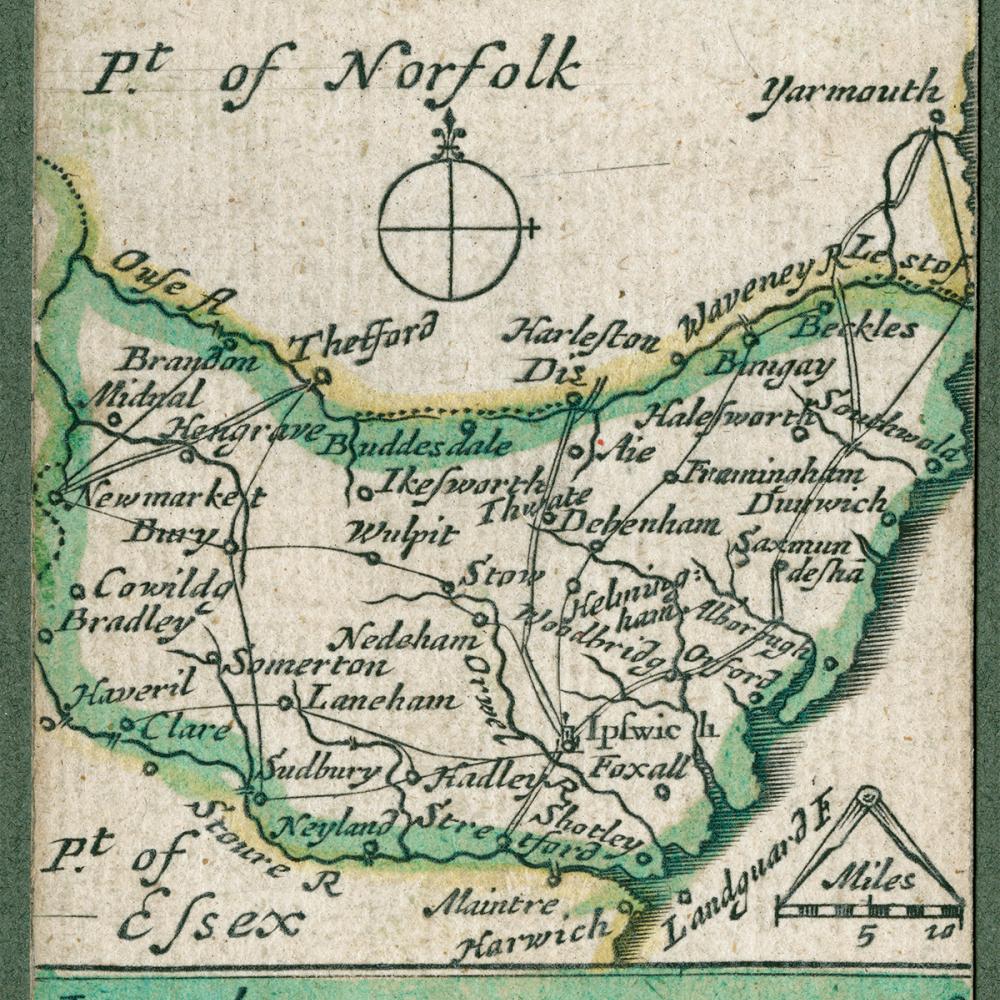 A color pocket map with mostly green outlines over yellowed paper showing the routes and dimensions of Suffolk, England.