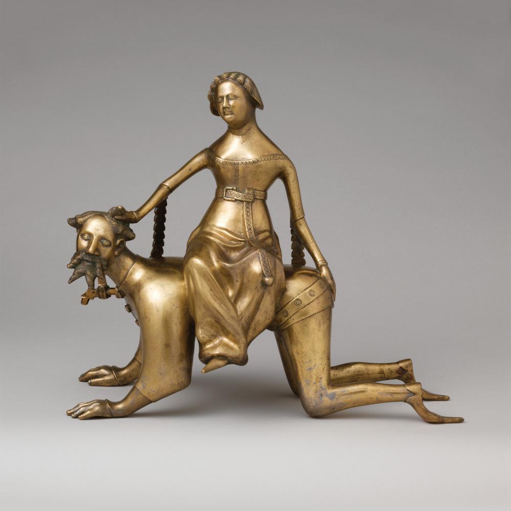Gold figure of Phyllis riding atop an Aristotle on all fours, as if he were a dog.