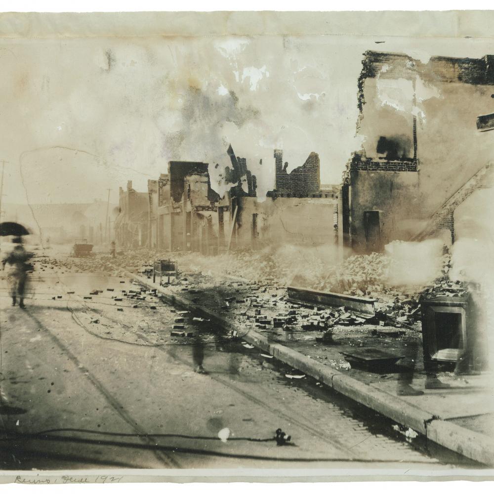 A blurred photo of the ruins of Greenwood after the 1921 Tulsa Massacre