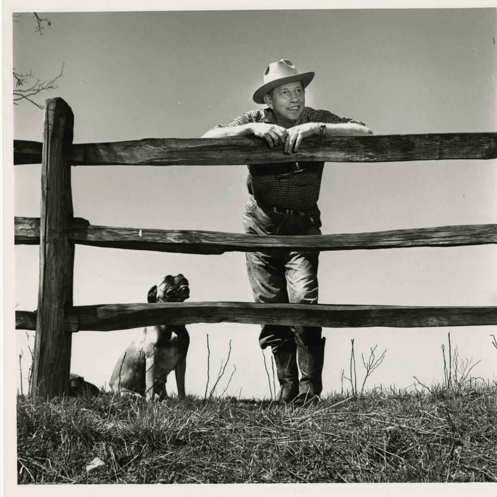 Bromfield leaning on fence