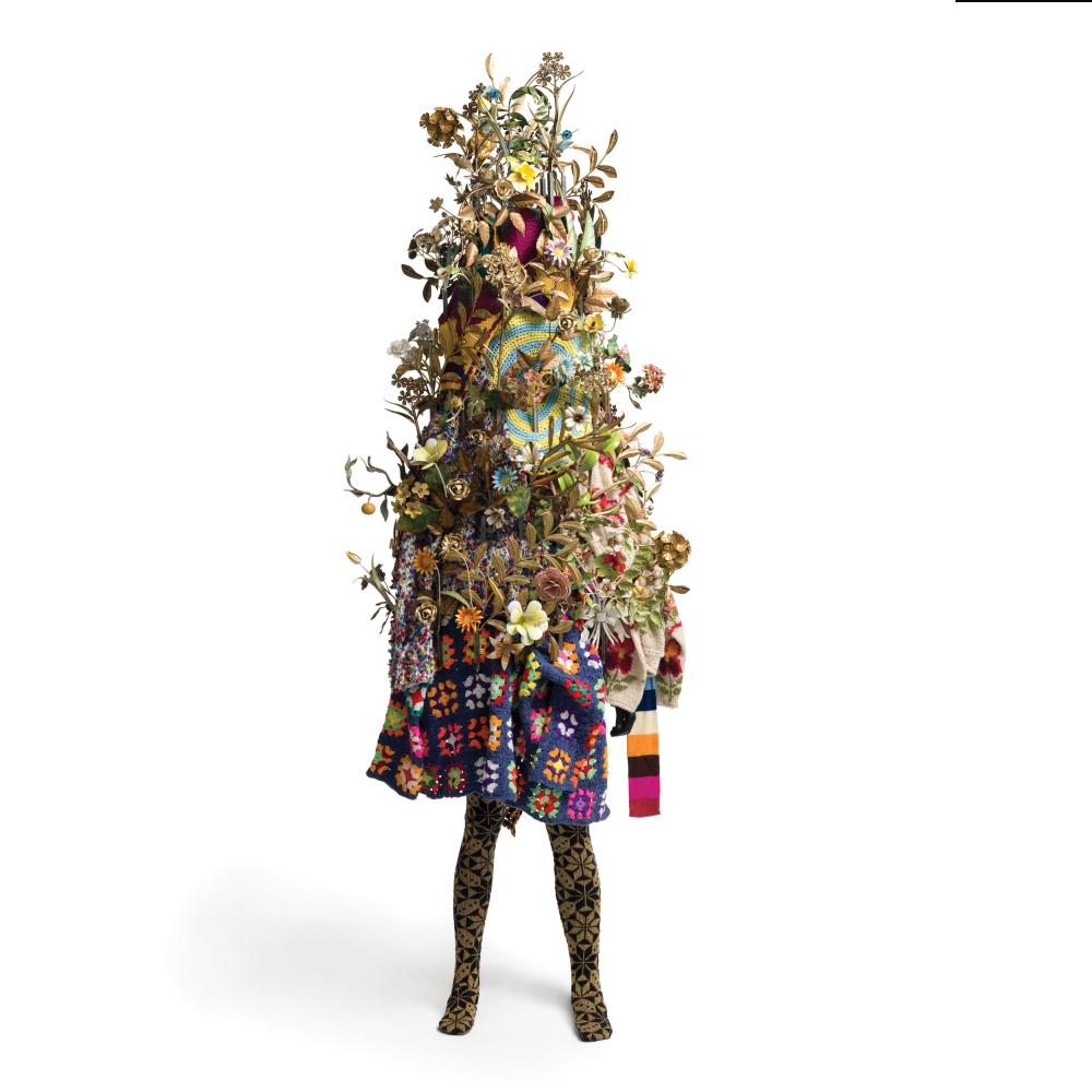 person wearing Nick Caves's soundsuit made of foliage and fabric