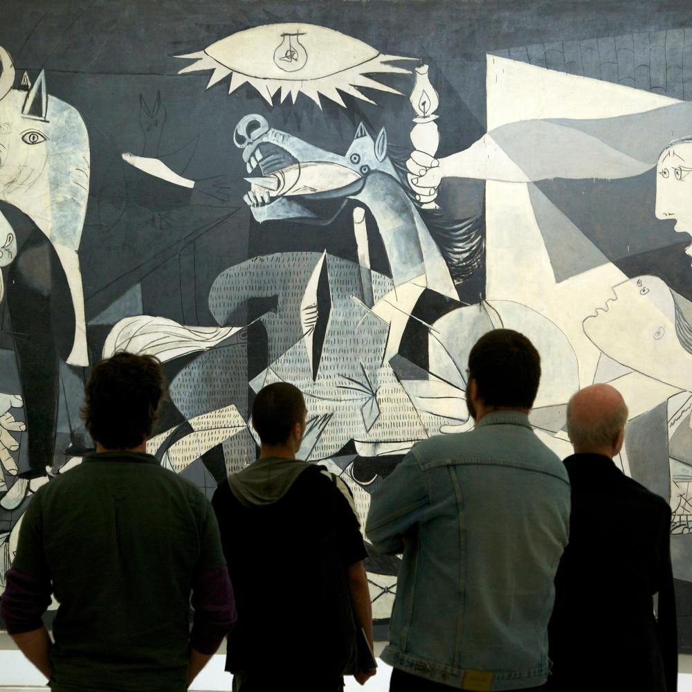 A crowd looks at Picasso's painting Guernica