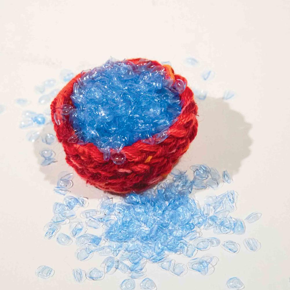 red woven basket filled with blue contacts to look like tears