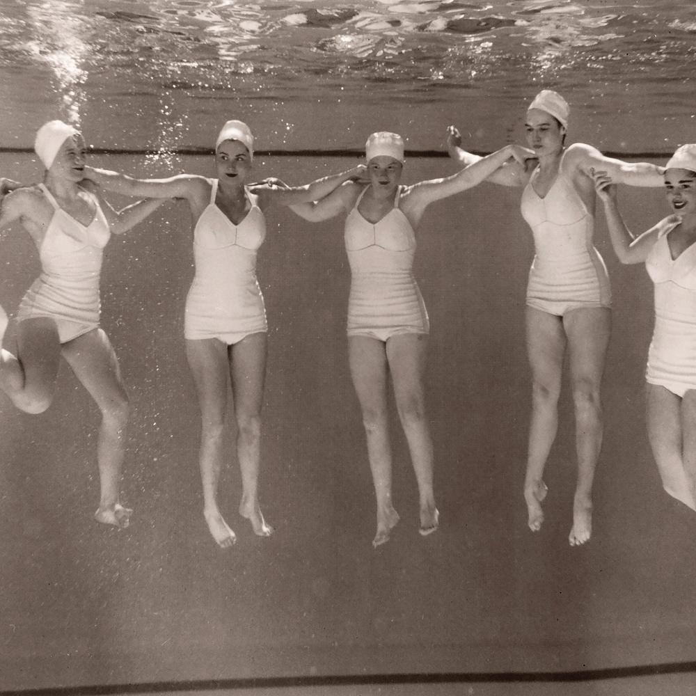 Women "dancing" underwater in pool