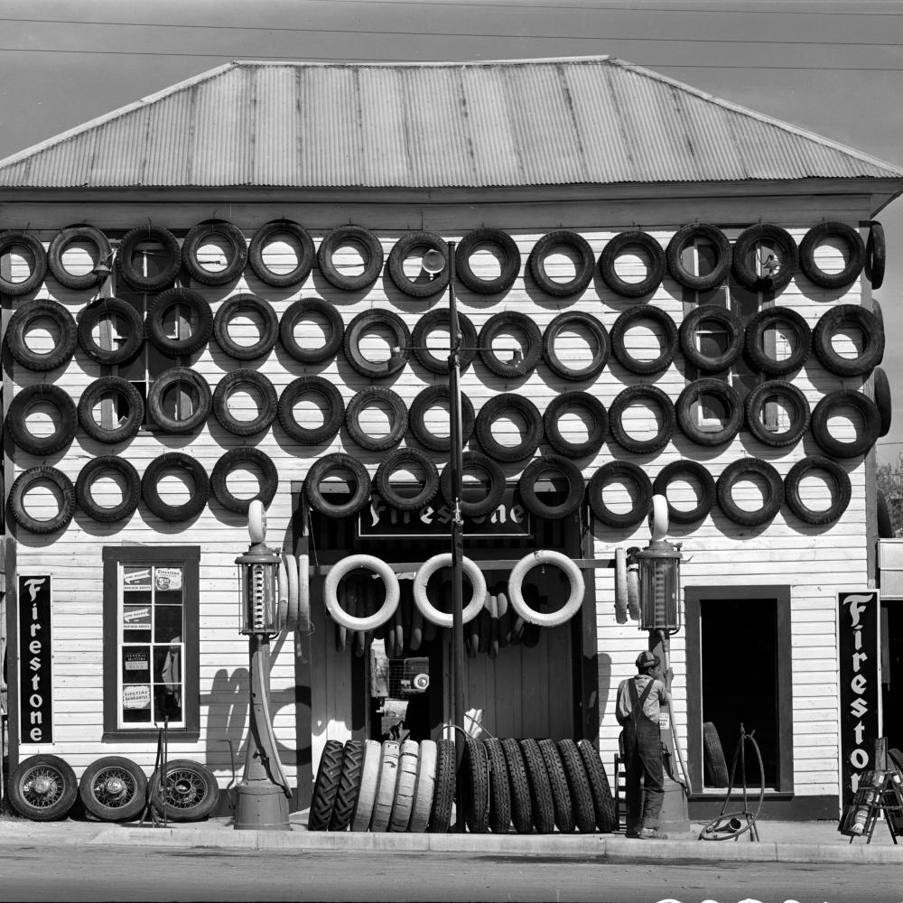 black and white photograph of building covered in used tires, 1940.