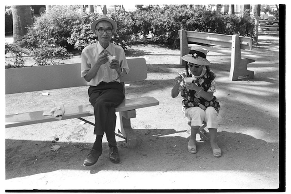 Two elderly people eating snowcones